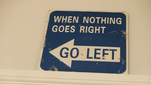 Metal sign on a wall saying When Noting Goes Right Go Left